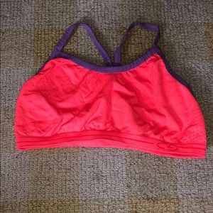 Bright orange sports bra with purple straps